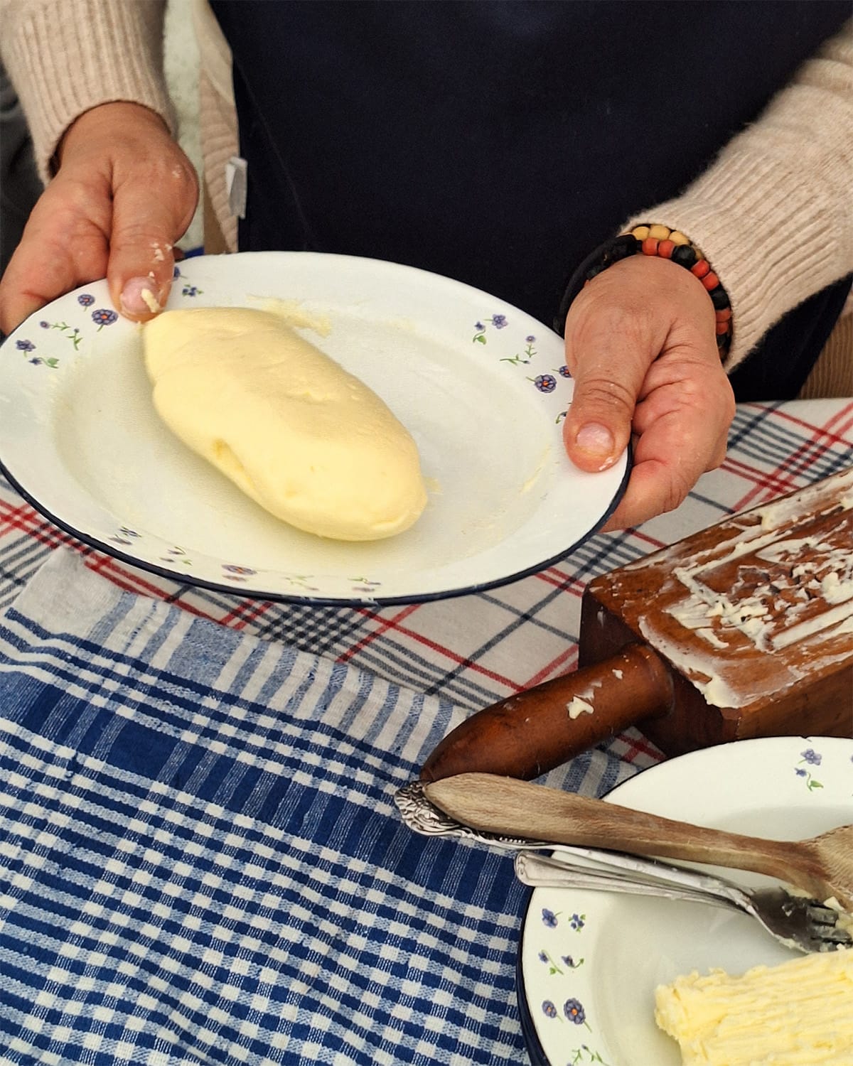 An artisan demonstrates the finalized butter in the butter-making workshop.