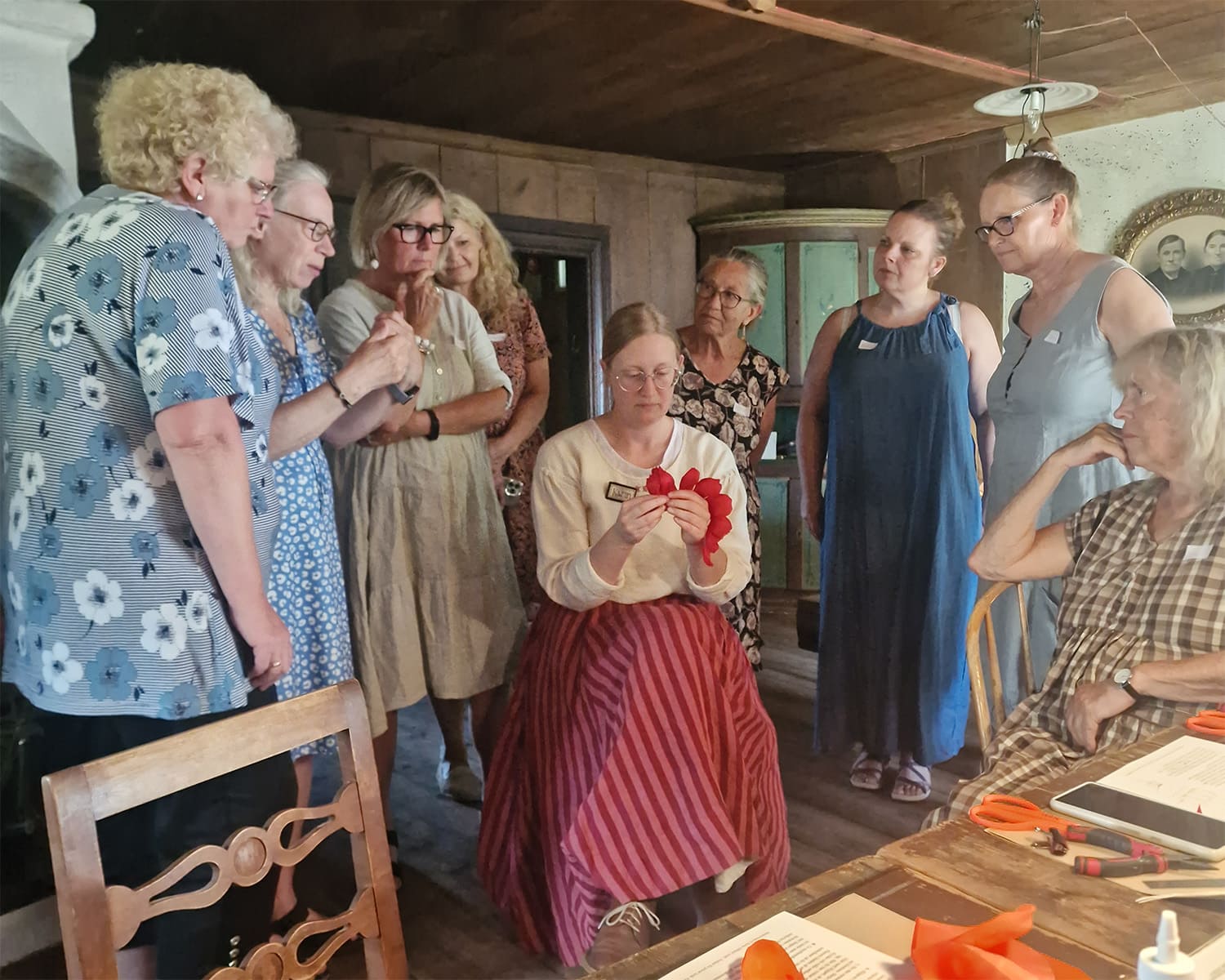 Artisan Karin Edlund teaching a class on paper flower-making.