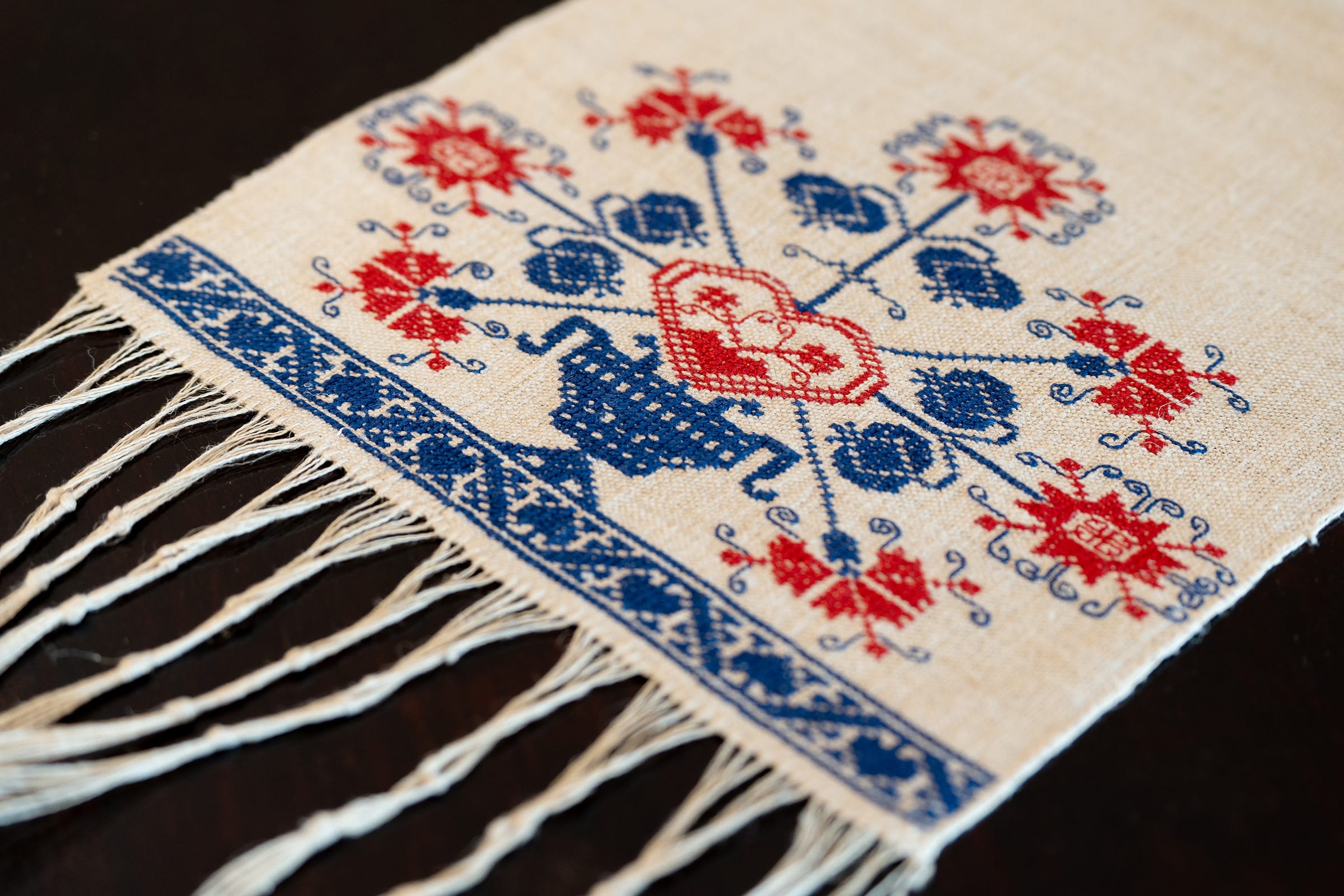Otirača is created using the counted thread technique with cross stitches.
The embroidery is made on hand-woven linen fabric from the Bela Krajina (White Carniola) region.
