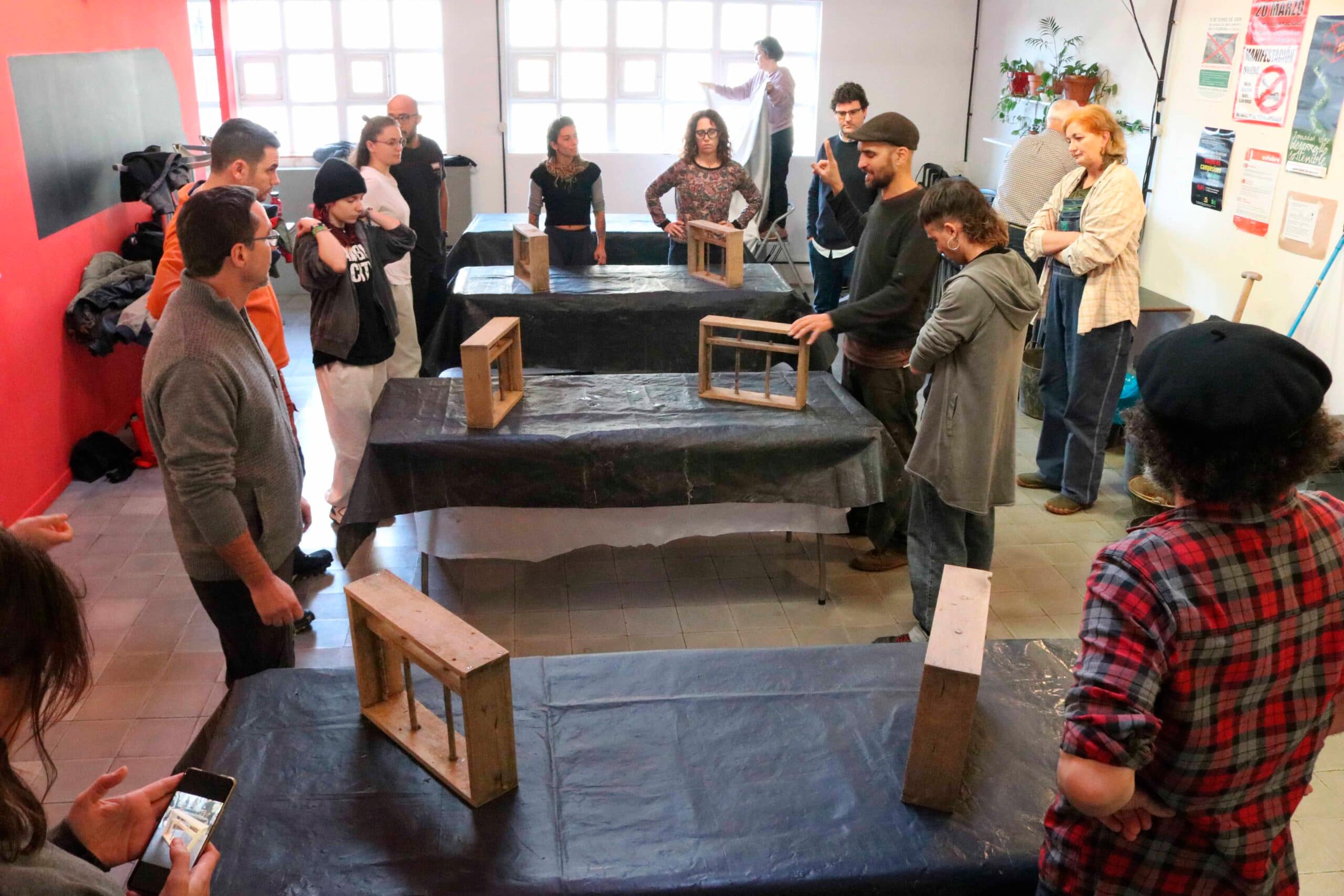 Participants listening attentively to instructor Macario Iglesias as he explains key bioconstruction techniques.