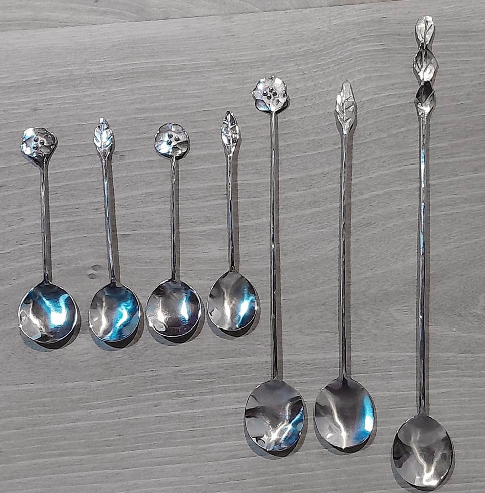 Figure 1 – Variety of stainless-steel spoons with different ornamental details inspired by nature, ranging from oak leaves to poppy flowers. Source: photo taken by the artisan.